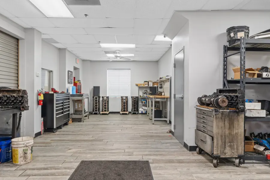 Engine machine shop workspace with tool chests and rolling shelves