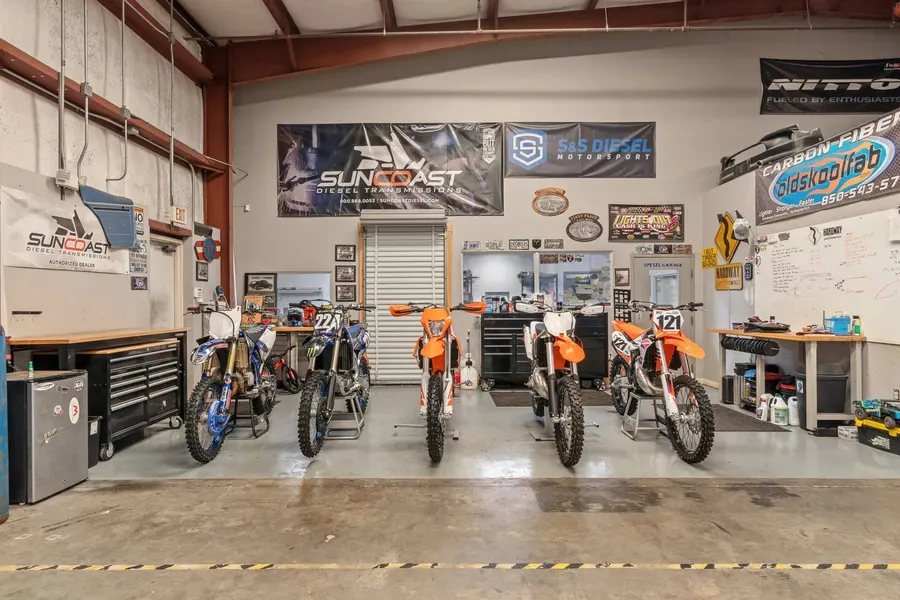 Motorsport shop interior with dirt bikes and sponsor banners