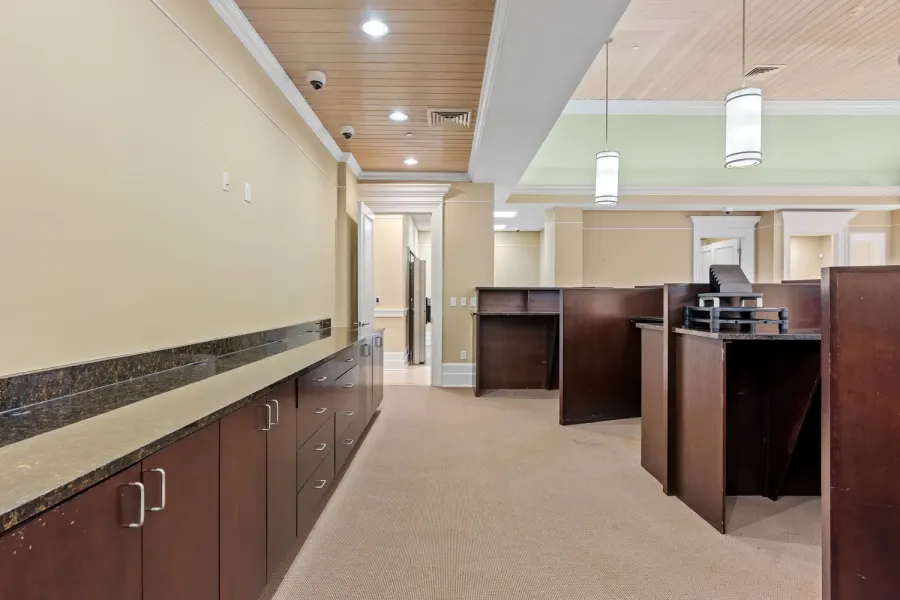 Office corridor with granite counters and wood workstations
