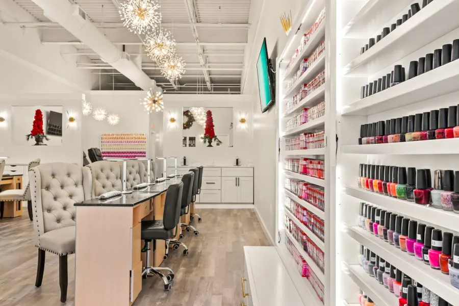 Modern nail salon with polish display walls and manicure stations