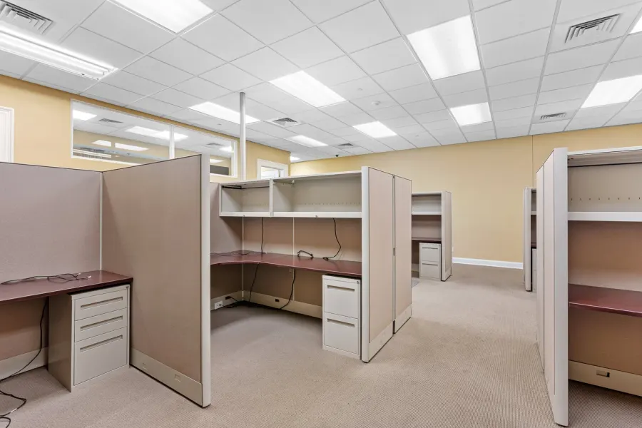 Open office space with cubicle workstations and drop ceiling