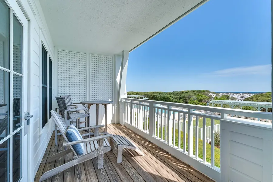 Covered balcony with Adirondack chairs overlooking dunes and the Gulf near Destin
