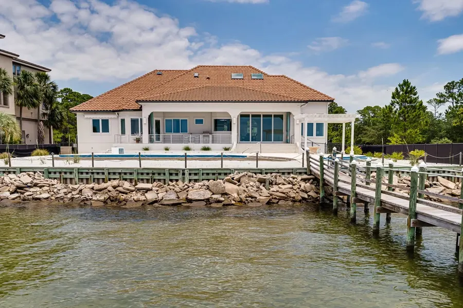Waterfront Florida home with tile roof, pool, and private dock