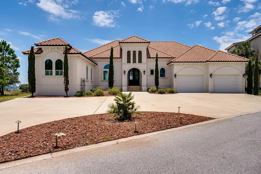 Tuscan-style Florida home with arched entry and three-car garage
