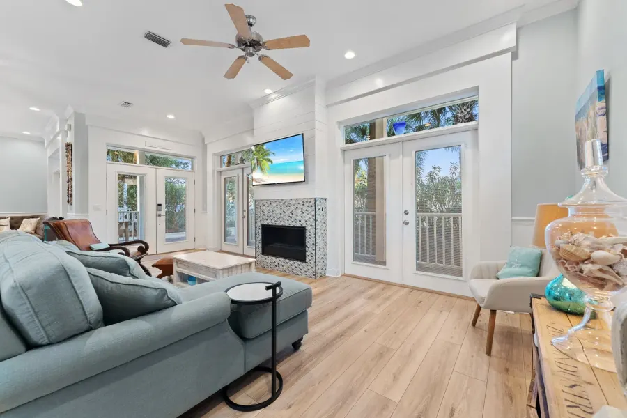 Coastal living room in a Destin beach home with French doors and seafoam sofa