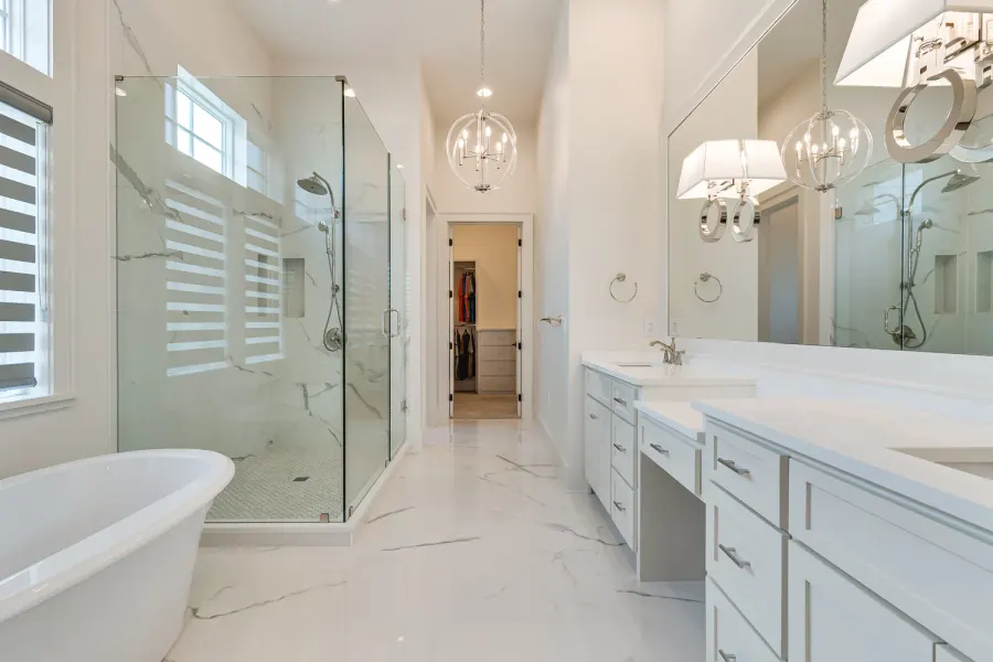 Bright marble master bath with freestanding tub and glass walk-in shower