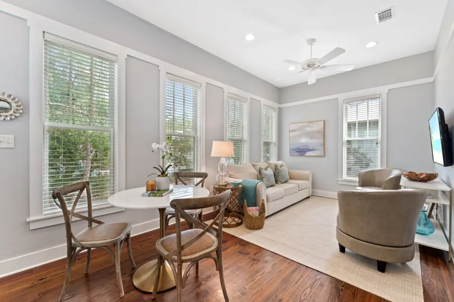 Sunlit gray sitting room with round bistro table and neutral sofa