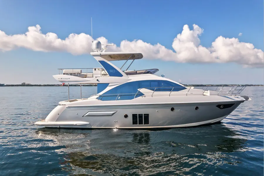 Azimut flybridge yacht at anchor on calm Emerald Coast water