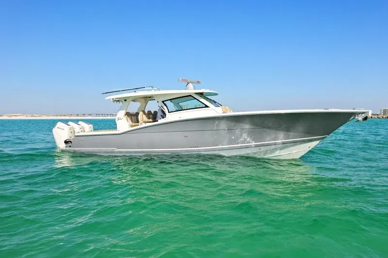Gray center console boat on emerald green water near Destin