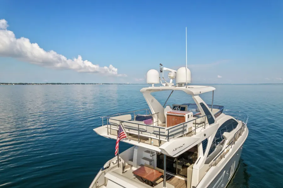 Aerial view of a flybridge yacht flying an American flag