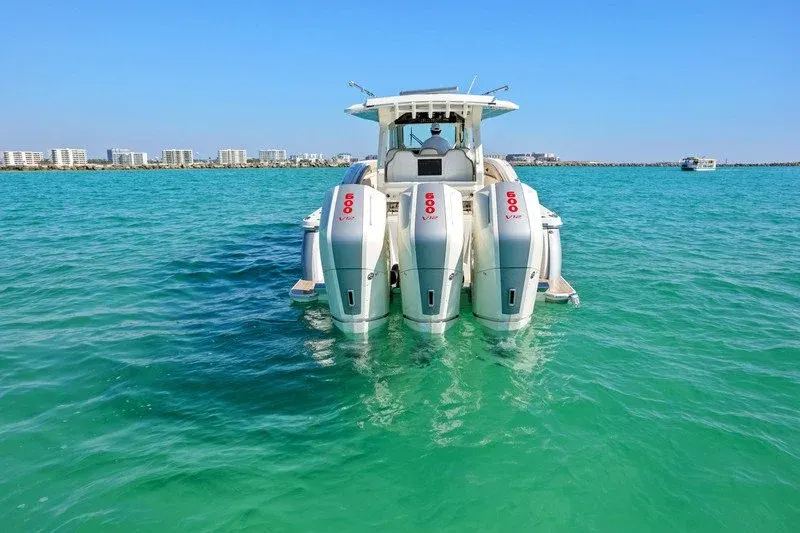 Triple 600 horsepower outboards on emerald water near Destin Harbor