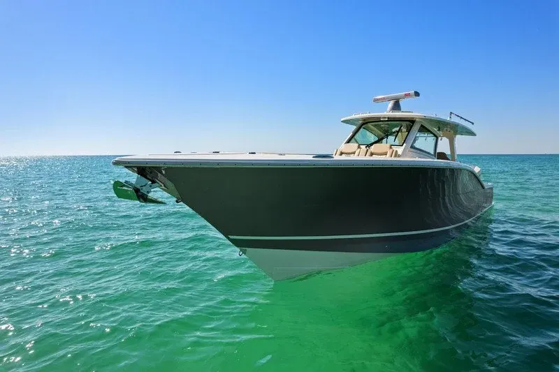 Dark-hulled center console boat floating on emerald green Destin water