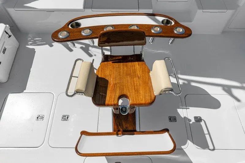 Overhead view of teak fighting chair and rocket launcher on fishing cockpit