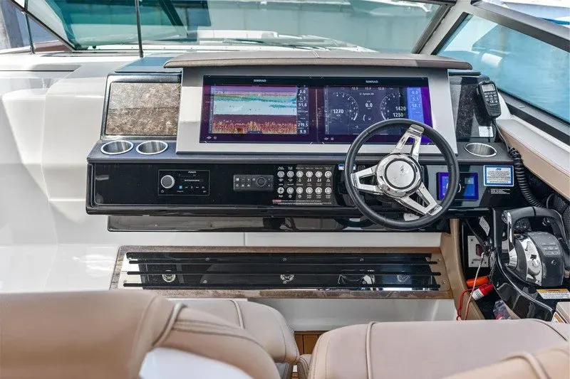 Boat helm station with dual navigation displays and sport steering wheel