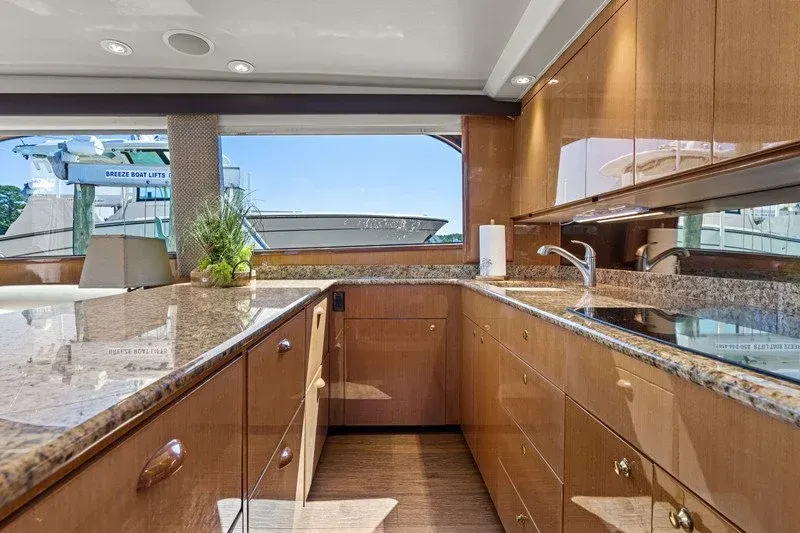 Yacht galley with granite counters and marina views through wide windows