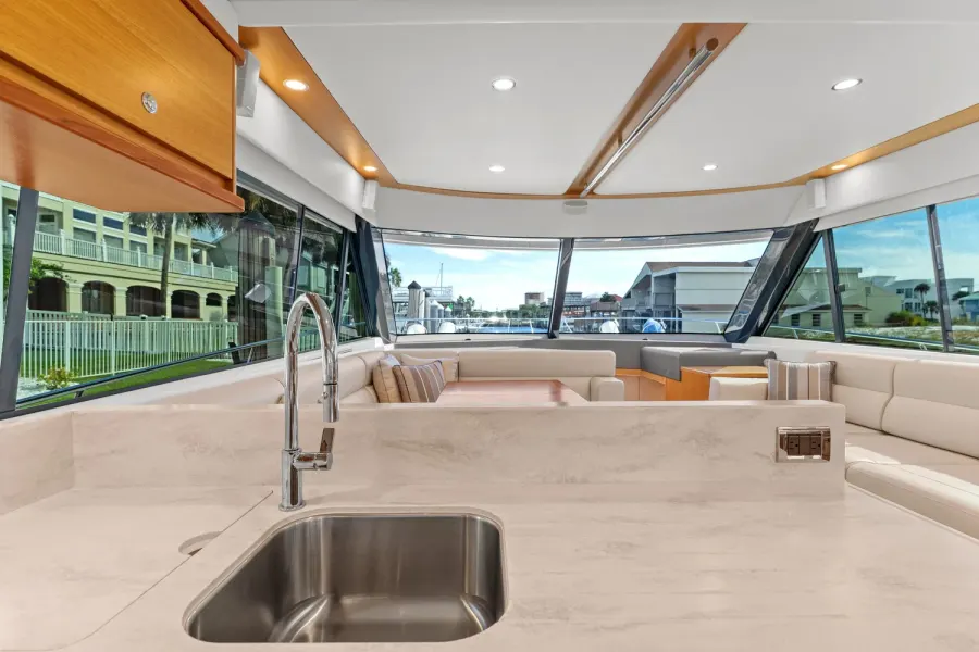Yacht salon wet bar with wraparound seating and Destin harbor views