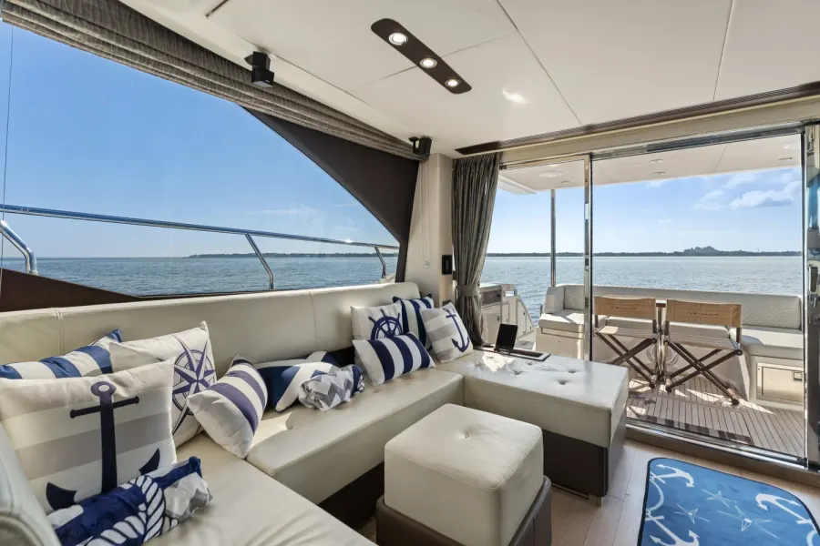 Nautical themed yacht lounge with anchor pillows opening to aft deck