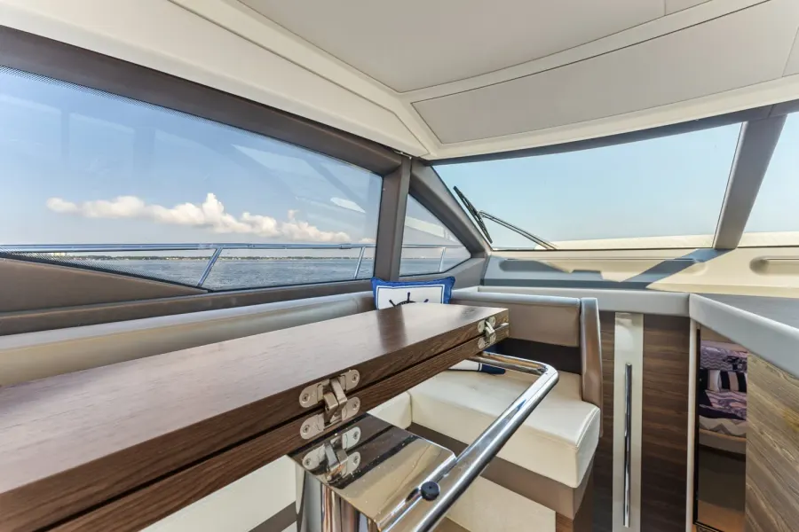 Yacht dinette with polished rail and open water views on the Emerald Coast