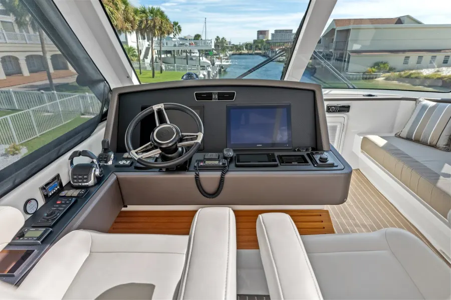 Yacht helm station with navigation screens overlooking a Destin canal