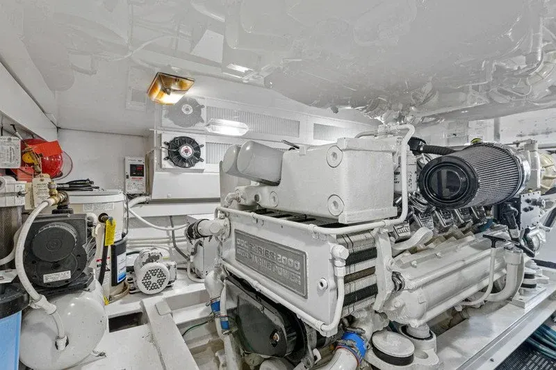 Clean white engine room with twin diesel motors and equipment